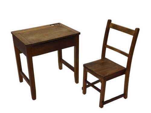 An early 20thC oak child's desk, with space for pens and inkwell, with hinged lid on square legs,...