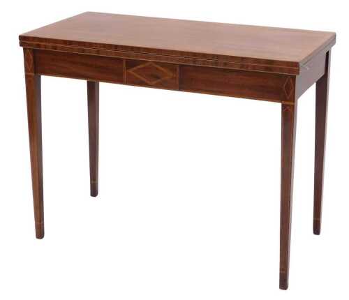 A late 19thC mahogany and boxwood strung foldover tea table, of rectangular form, the plain top...