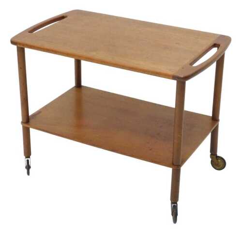 A 1970s G Plan style teak two tier trolley, with side handles on turned supports, joined by an...
