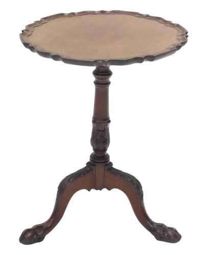 A late 19thC walnut and mahogany tripod wine table, the top with pie crust edge on a heavily...