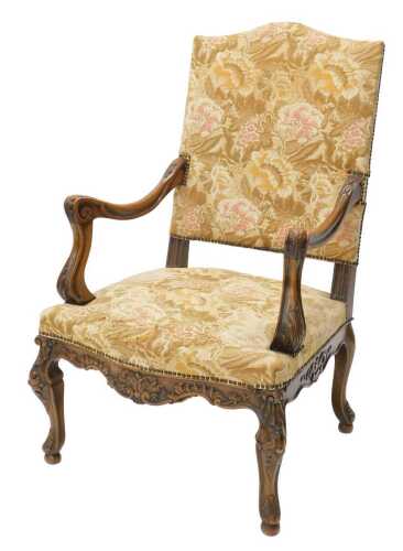 A early 20thC walnut framed armchair, of large proportion, with serpentine top, overstuffed back...