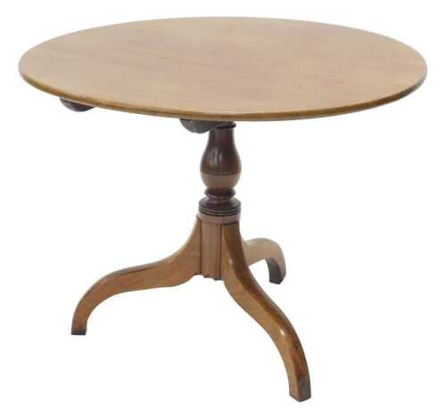 A 19thC mahogany supper table, the circular top on baluster stem, terminating in triple sabre...