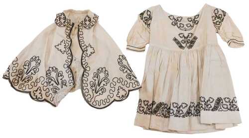 A late 19thC child's worked dress, with shawl decorated with a floral pattern, 54cm high.