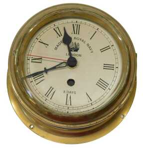 A brass cased ship's clock, the circular dial bearing Roman numerals and Made for Royal Navy...