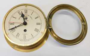A brass cased ship's clock, the circular dial bearing Roman numerals and Made for Royal Navy... - 2