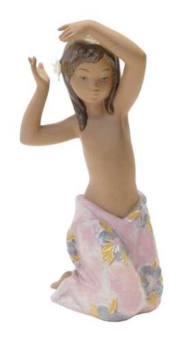 A Lladro porcelain figure modelled as Tropical Flower Girl, number 2385, 26cm high.