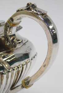 A George V silver teapot, of semi fluted form, raised on four ball feet, with an ebonised knop... - 4