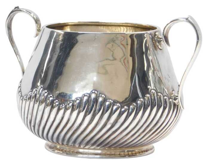 A Victorian silver twin handled sugar bowl, of semi fluted form, raised on an oval foot, Martin,...