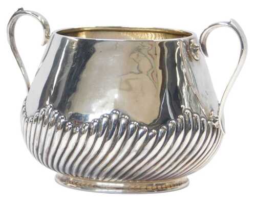A Victorian silver twin handled sugar bowl, of semi fluted form, raised on an oval foot, Martin,...