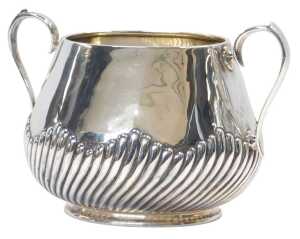 A Victorian silver twin handled sugar bowl, of semi fluted form, raised on an oval foot, Martin,...