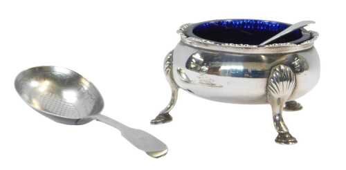 A George III silver open salt, of cauldron form, raised on three shell capped hoof feet, with a...