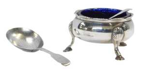 A George III silver open salt, of cauldron form, raised on three shell capped hoof feet, with a...