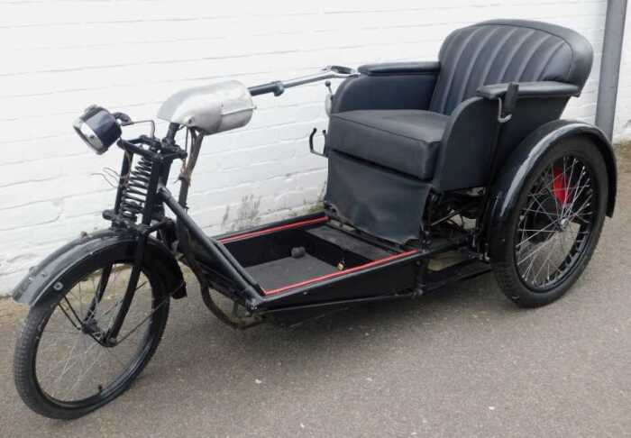 A 1936 Argson Electric three wheeled invalid carriage, registration DBH 889, in black trim with...