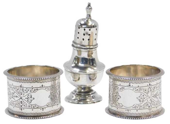 A pair of Victorian silver napkin rings, profusely decorated with leaf and flower bud motifs,...