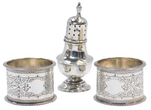 A pair of Victorian silver napkin rings, profusely decorated with leaf and flower bud motifs,...