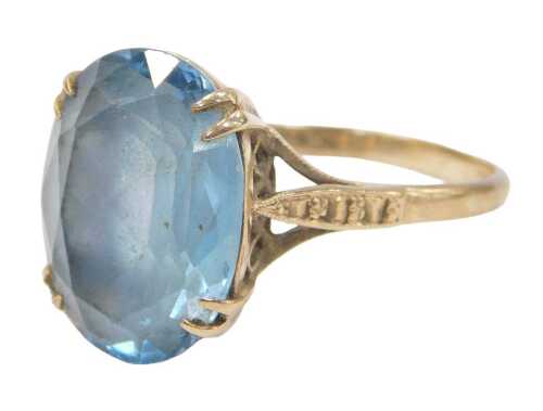 A blue zircon dress ring, the oval faceted stone in a double four claw setting, on a raised...