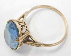 A blue zircon dress ring, the oval faceted stone in a double four claw setting, on a raised... - 2