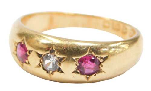 An Edwardian 18ct gold ruby and diamond three stone gypsy ring, with three star illusion set...
