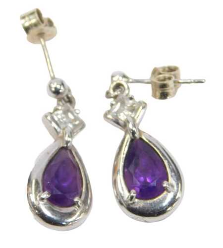 A pair of 9ct white gold and amethyst drop earrings, each with a cz set top, on single pins with...