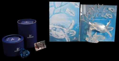 A Swarovski crystal Wonders of the Sea group titled Eternity, with a name plaque and 2006 blue...