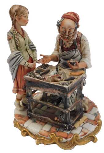 A Capodimonte porcelain figure group, modelled as a gentleman cobbler beside a girl, gilt...