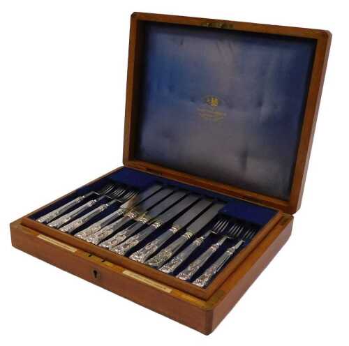 A set of twelve Kings pattern silver plated dessert knives and forks, contained in an oak fitted...