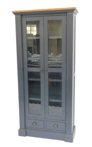 A contemporary dark blue painted two door cabinet, the oak veneer top above two glass fronted...