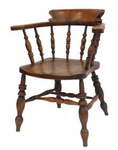 A 19thC ash and elm smoker's bow chair, with a turned columned back and scrolling arms, the...