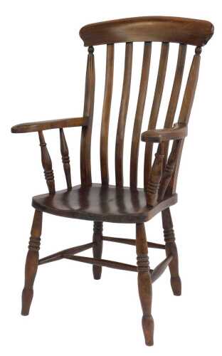 A late 19thC oak and elm lath back grandfather chair, with a solid seat, raised on turned legs...