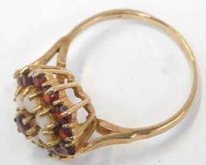 A 9ct gold cluster ring, set with garnets and opals, each concentric claw set in a raised basket,... - 2