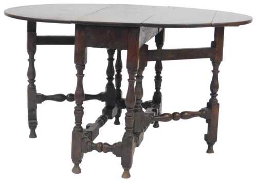 An early 18thC oak gate leg table, the oval top on turned supports with tapering feet, 72cm high,...