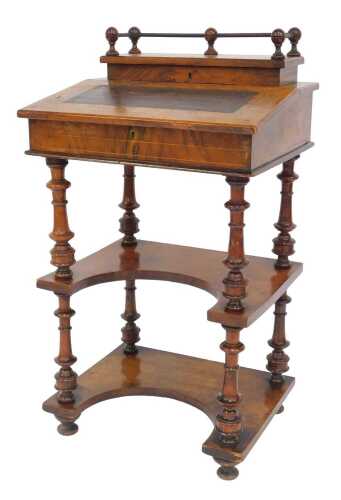 A Victorian walnut and line inlaid desk, the top with a lidded compartment for pens, with a...