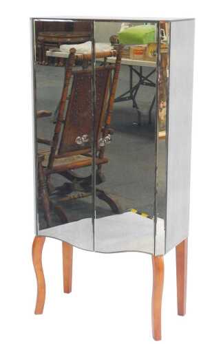 A contemporary mirrored two door cabinet, enclosing two glass shelves, raised on hardwood...