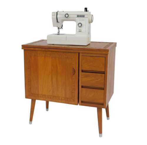 A mid 20thC Oriental camphor wood sewing machine table, decorated with a leaf carved border,...