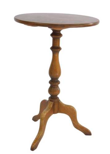 An Ercol Old Colonial elm tripod table, the circular top raised on a turned column, raised on...