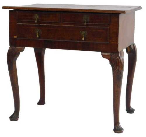 A mid 18thC walnut lowboy, the rectangular top with a crossbanded border above an arrangement of...