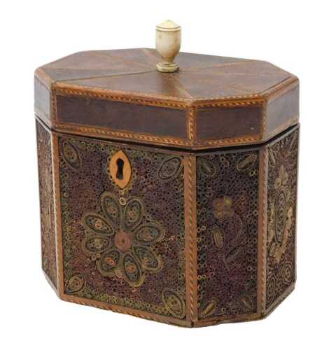 A Georgian quill work tea caddy, of canted form, the hinged lid with a bone urn finial, opening...