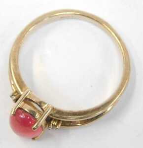 A 9ct gold and cabochon dress ring, the red cabochon in a raised basket with two tiny diamond... - 2