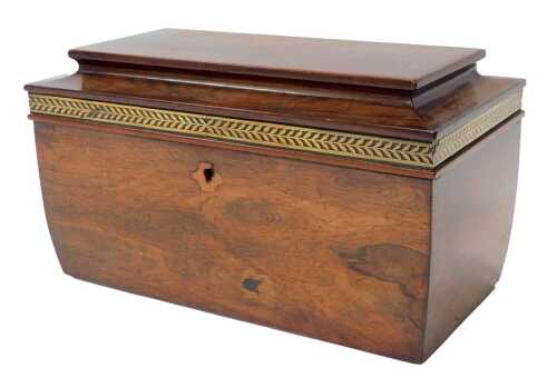 A Regency rosewood sarcophagus-shaped tea caddy, the lid decorated with a pierced brass border...