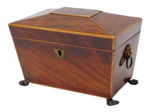 A Regency mahogany and boxwood line-inlaid sarcophagus-shaped tea caddy, the hinged lid...