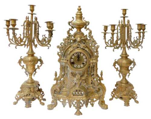An early 20thC EHG Germany Rococo style brass clock garniture, the clock dial bearing Roman...