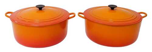 A pair of Le Creuset volcanic orange twin handled casserole dishes, each with a lid, 34.5cm...