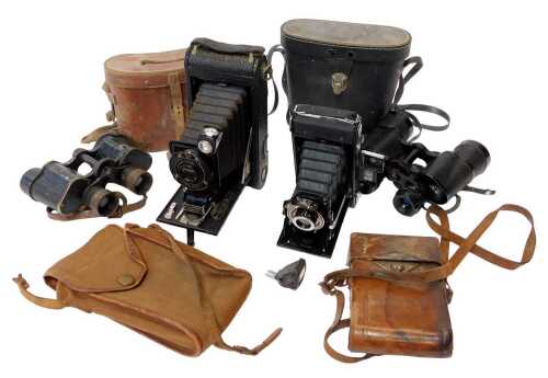 A group of cameras and optical-related equipment, to include a Kodak A-116 folding camera, a...