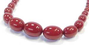 A graduated cherry amber necklace, of fifty seven beads, the largest 3.5cm wide, the smallest... - 2