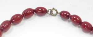 A graduated cherry amber necklace, of fifty seven beads, the largest 3.5cm wide, the smallest... - 3