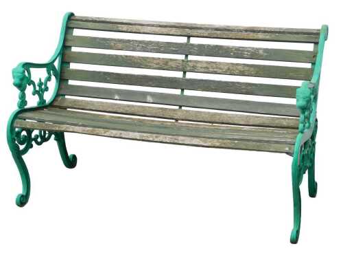 A garden bench, with green painted cast iron ends, and a wooden slatted seat and back, 131cm wide.
