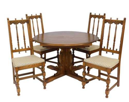An Ercol elm Old Colonial extending dining table, the circular top with a rounded edge, raised...