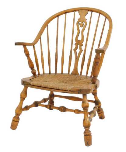 A 19thC beech country chair, with loop back, pierced splat and spindle supports, with a rush...