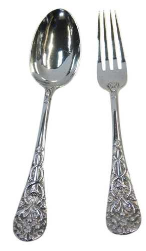 A Victorian silver Christening set, comprising fork and spoon, each handle profusely decorated...