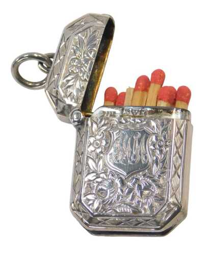 A George V silver Vesta case, initialled and profusely decorated with flowers and scrolling...
